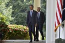 U.S. President Obama walks with Vice President Biden to the Rose Garden of the White House to make remarks on the situation in Syria