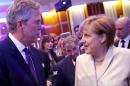 German Chancellor Merkel talks to former Florida Governor and potential Republican presidential candidate Bush after he addressed the CDU party economic council in Berlin