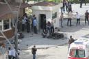 Police forensic experts inspect the scene after an explosion in front of the city's police headquarters in Gaziantep