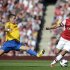 Arsenal's Lukas Podolski challenges Southampton's Morgan Schneiderlin during their English Premier League soccer match in London