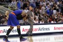 New York Knicks' Anthony reacts after being hit in the face during their NBA basketball game against the Dallas Mavericks in Dallas