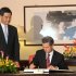 Hong Kong Chief Executive Leung Chun-Ying, left, watches as Mexican President Enrique Pena Nieto, right, signs the guest book before their official talks at Government House in Hong Kong on Friday April 5, 2013.  Enrique Pena Nieto arrived in Hong Kong on a trip aimed at deepening economic ties and widening relations with the Asia-Pacific region. (AP Photo / Dale de la Rey)