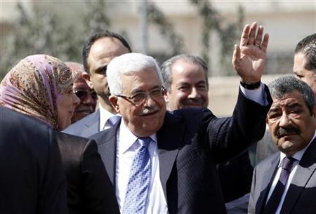 Palestinian President Abbas waves as he arrives at a polling station in Al-Bireh