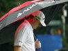 Chad Campbell keeps away from the rain during the final round of the Wyndham Championship golf tournament in Greensboro, N.C., Sunday, Aug. 19, 2012. (AP Photo/Gerry Broome)