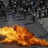 Flames from a molotov cocktail flare up near Greek riot police as they stand guard near a protest march by Greece's Communist party in central Athens during a 24-hour labour strike