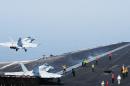 This US Navy photo obtained August 8, 2014 shows sailors directing aircraft, as an F/A-18E Super Hornet takes off from the aircraft carrier USS George H.W. Bush on August 1, 2014 in the Gulf