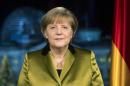 German Chancellor Angela Merkel poses for photographs after the recording of her annual New Year's speech at the Chancellery in Berlin