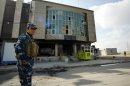 A guard outside the Gordan party's attacked offices in the Kurdish city of Arbil in northern Iraq on February 18, 2011