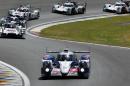 The Toyota TS040 Hybrid driven by Japanese driver Kazuki Nakajima, France's Stephane Sarrazin and Austria's Alexander Wurtz, foreground, takes a bend during the 82th 24-hour Le Mans endurance race, in Le Mans, western France, Saturday, June 14, 2014. (AP Photo/Bob Edme)