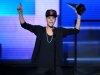 FILE - In this Nov. 18, 2012 file photo, Justin Bieber accepts the award for favorite album - pop/rock for "Believe" at the 40th Anniversary American Music Awards, in Los Angeles. On Jan. 1, 2013, a paparazzo was struck by a car and killed in Los Angeles while pursuing photos of Bieber's white Ferrari. Bieber was not in the car. (Photo by John Shearer/Invision/AP, File)