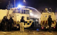Police use water cannon on loyalist rioters in north Belfast (AP)