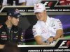 Red Bull Formula One driver Vettel talks with Schumacher during a news conference at the Interlagos racetrack in Sao Paulo