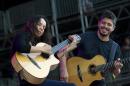 FILE - This June 8, 2012 file photo shows Gabriela Quintero, left, and Rodrigo Sanchez of Rodrigo Y Gabriela performing during the Bonnaroo Music and Arts Festival in Manchester, Tenn. The group released a new album titled, "9 Dead Alive." (AP Photo/Dave Martin)