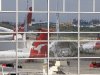 Idle Qantas planes are reflected in a window at Sydney Airport in Sydney, Sunday, Oct. 30, 2011. Qantas Airways grounded all of its aircraft around the world indefinitely Saturday due to ongoing strikes by its workers. (AP Photo/Rick Rycroft)