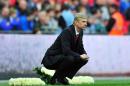 Arsenal's manager Arsene Wenger looks on from the touchline during their English FA Cup semi-final match against Wigan Athletic at Wembley Stadium in London on April 12, 2014