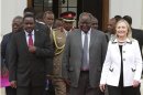 Kenya's President Mwai Kibaki, flanked by U.S. Secretary of State Hillary Clinton and his vice-president Kalonzo Musyoka, leaves after a meeting at State House in capital Nairobi