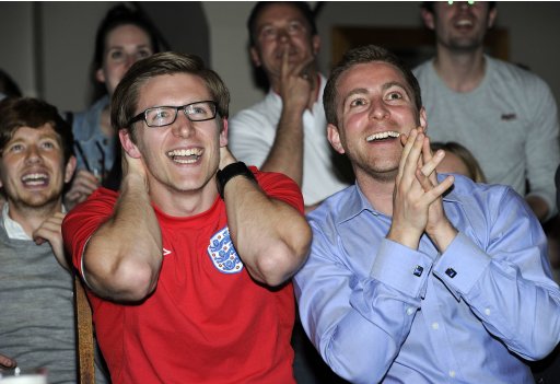 England fans react watching England's Euro 2012 soccer match against Ukraine at a pub in London
