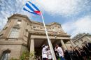 Cuban Foreign Minister Bruno Rodriguez raises the Cuban flag over the country's new embassy in Washington on July 20, 2015