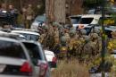 FBI agents prepare to patrol the woods on Lower Swiftwater Road on Saturday, Oct. 18, 2014, during a massive manhunt for killer Eric Frein in Swiftwater, Pa. (AP Photo / The Scranton Times-Tribune, Butch Comegys)