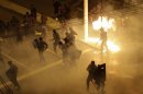 Riot police clash with demonstrators during a protest on the streets of Rio de Janeiro