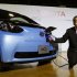 Toyota's Executive Vice President Uchiyamada poses next to the company's newly developed compact electric vehicle eQ after a news conference in Tokyo