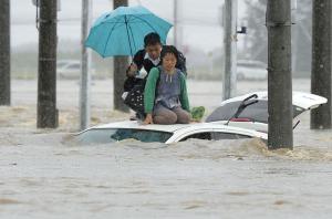 People wait for help as the vehicles are submerged&nbsp;&hellip;