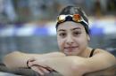 FILE - This is a Monday, Nov. 9, 2015 file photo of Yusra Mardini from Syria poses during a training session in Berlin, Germany. They've fled war and violence in the Middle East and Africa. They've crossed treacherous seas in small dinghies and lived in dusty refugee camps.They include a teenage swimmer Yusra Mardini from Syria, long-distance runners from South Sudan and judo and taekwondo competitors from Congo, Iran and Iraq. They are striving to achieve a common goal: To compete in the Olympics in Rio de Janeiro. Not for their home countries, but as part of the first ever team of refugee athletes.(AP Photo/Michael Sohn, File)