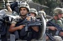 Lebanon's army soldiers hold their guns while securing an area, where clashes between the army and Sunni Muslim gunmen took place, in Beirut