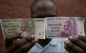 A man holds up newly issued 200 million and 500 million Zimbabwe dollar notes in the capital Harare