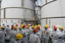 Members of a Fukushima prefecture panel inspect a contaminated water tank TEPCO's tsunami-crippled Fukushima Daiichi nuclear power plant in Fukushima