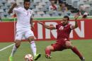 UAE's Ali Ahmed Mabkhout (left) and Qatar's Ahmed Mohamed during their Asian Cup match in Canberra on January 11, 2015, which UAE won 4-1