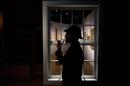 Curator Timothy Long is silhouetted as he poses for photographers with a Sherlock Holmes style pipe and deerstalker hat beside an internal window forming part of the exhibition "Sherlock Holmes: The Man Who Never Lived and Will Never Die" at the Museum of London in London, Thursday, Oct. 16, 2014. The exhibition, which opens to the public on Friday, is the largest on the fictional detective created by Scottish author Sir Arthur Conan Doyle to be held in the UK for 60 years (AP Photo/Matt Dunham)