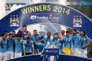 Manchester City players pose together with the League Cup after winning against Sunderland at Wembley Stadium in London on March 2, 2014