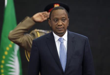 Kenya&#39;s President Kenyatta stands for Kenya&#39;s national anthem before the Africa Union Peace and Security Council Summit on Terrorism at the...