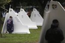 A man with the Australian flag confesses at the confessional booths set up at Quinta da Boa Vista park at the World Youth Day in Rio de Janeiro
