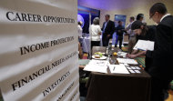 <p>               FILE - In this July 25, 2012, file photo, people looking for work talk at a Primerica job booth at a job fair in San Jose, Calif. U.S. hiring was likely sluggish in July for a fourth straight month, held back by slower economic growth and an uncertain outlook. (AP Photo/Paul Sakuma, File)