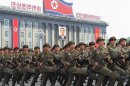 North Korean soldiers parade in front a portrait of former North Korean President Kim Il-sung during a military parade in Pyongyang