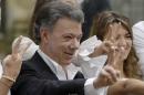 FILE - In this Sunday, Oct. 2, 2016 file photo Colombia's President Juan Manuel Santos makes the victory sign after voting in a referendum to decide whether or not to support the peace deal he signed with rebels of the Revolutionary Armed Forces of Colombia, FARC, in Bogota, Colombia. Colombia's government and rebels from the National Liberation Army have agreed to revive a stalled peace effort, providing a boost to President Juan Manuel Santos as he tries to recover from voters' shocking rejection of a deal with the much-larger FARC guerrilla group, it was announced on Monday, Oct. 10. (AP Photo/Ricardo Mazalan, File)