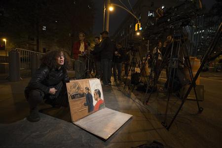 Sketch artist Jane Rosenberg shows reporters her drawing of Gilberto Valle III, 28, when he pleaded not guilty to criminal charges in the U.S. District Court in Manhattan, in New York October 25, 2012. REUTERS/Keith Bedford