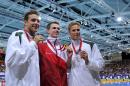 (L-R) Silver medallist South Africa's Roland Schoeman, Gold medallist England's Benjamin Proud and Bronze South Africa's Chad le Clos pose after the Men's 50m Butterfly medal ceremony during the Commonwealth Games in Glasgow on July 25, 2014