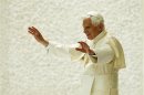 Pope Benedict XVI waves as he leaves after leading his Wednesday general audience in Paul VI's Hall at the Vatican