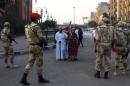 Pedestrians look as the Egyptian army soldiers divert traffic away from the Egyptian museum in Cairo