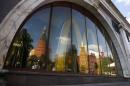 The walls and towers of the Kremlin are reflected in a window of a closed McDonald's restaurant, one of four temporarily closed by the state food safety watchdog, in Moscow