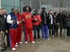Flamboyant former NBA star Dennis Rodman, fifth from right, poses with three members of the Harlem Globetrotters basketball team, in red jerseys, and a production crew for the media upon arrival at Pyongyang Airport, North Korea, Tuesday, Feb. 26, 2013. Rodman known as "The Worm" arrived in Pyongyang, becoming an unlikely ambassador for sports diplomacy at a time of heightened tensions between the U.S. and North Korea. (AP Photo/Kim Kwang Hyon)