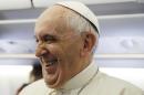 Pope Francis laughs as he meets the journalists aboard the papal airplane on the occasion of his visit to Quito, Ecuador, July 5, 2015. The Pontiff is visiting Ecuador, Bolivia and Paraguay during his Apostolic trip from July 5 to July 12. (AP Photo/Gregorio Borgia)
