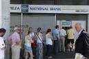 People line up to use ATM machines of a bank after government's decision for limited daily cash withdrawals to 60 euros ($67), in Athens, on Monday, July 6, 2015. Greek Finance Minister Yanis Varoufakis resigned Monday, saying he was told shortly after Greece's decisive referendum result that some other eurozone finance ministers and the country's other creditors would appreciate his not attending the ministers' meetings. (AP Photo/Thanassis Stavrakis)