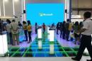 People visit the Microsoft booth during the 2015 Computex exhibition at the TWTC Nangang exhibition hall in Taipei