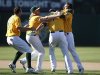 Oakland Athletics' Nate Freiman is congratulated by teammates after hitting the game-winning single during their MLB game against the New York Yankees in Oakland