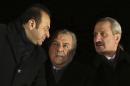 In this photo taken late Tuesday, Dec. 24, 2013, Turkey's Economy Minister Zafer Caglayan, right, Interior Minister Muammer Guler, center, and EU Affairs Minister Egemen Bagis speak at the Esenboga Airport in Ankara, Turkey. Guler and Caglayan resigned from their posts on Wednesday, Dec. 25, 2013, days after their sons were arrested in a massive corruption and bribery scandal that has targeted Prime Minister Recep Tayyip Erdogan's allies and has become the worst crisis in his decade in power. Caglayan and Guler both stepped down on Wednesday, despite denying any wrongdoing. (AP Photo)