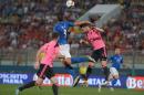 Italy's Graziano Pelle (C) fights for the ball with Scotland's Russell Martin (R) at the National Stadium in Ta'Qali, Malta on May 29, 2016